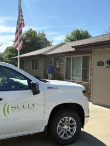 A white Sully Telephone pickup parked in a driveway